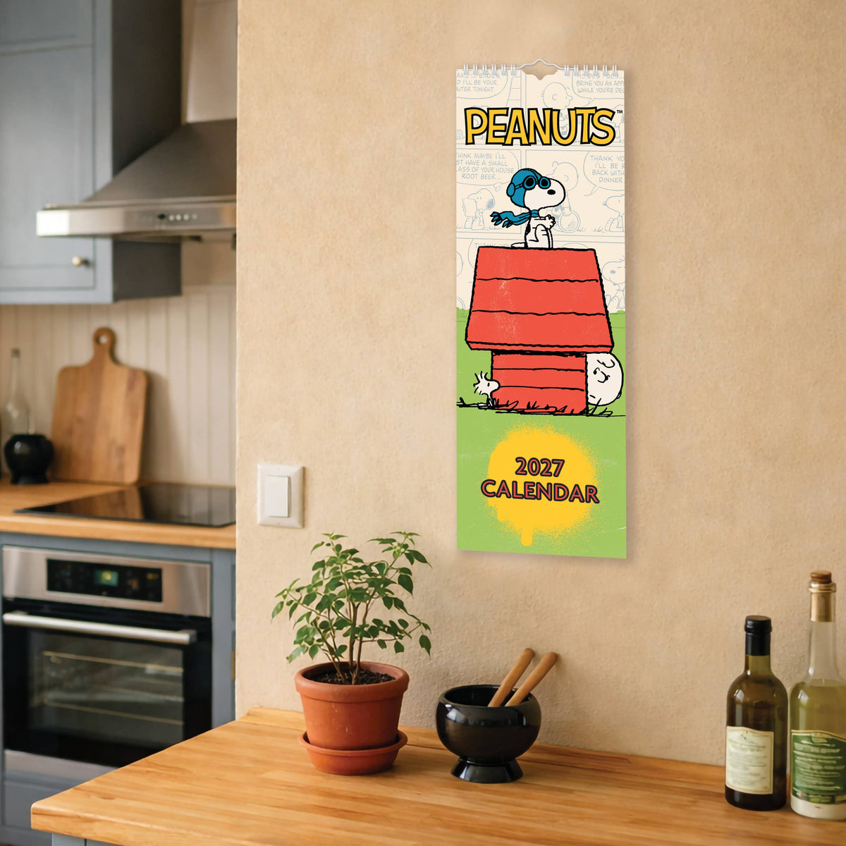 Peanuts slim calendar hanging on a kitchen wall