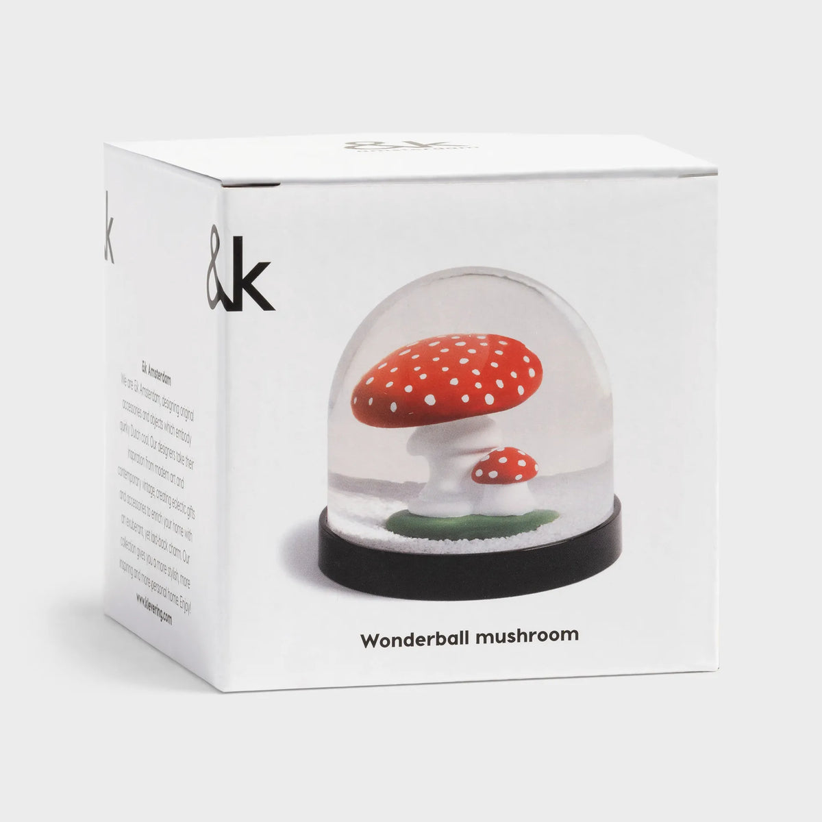 Mushroom snow globe in front of its box