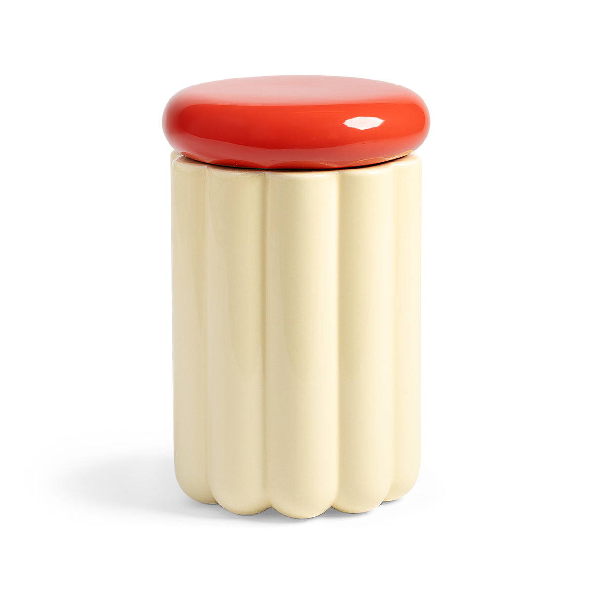 Cream ribbed ceramic storage jar with a round red lid