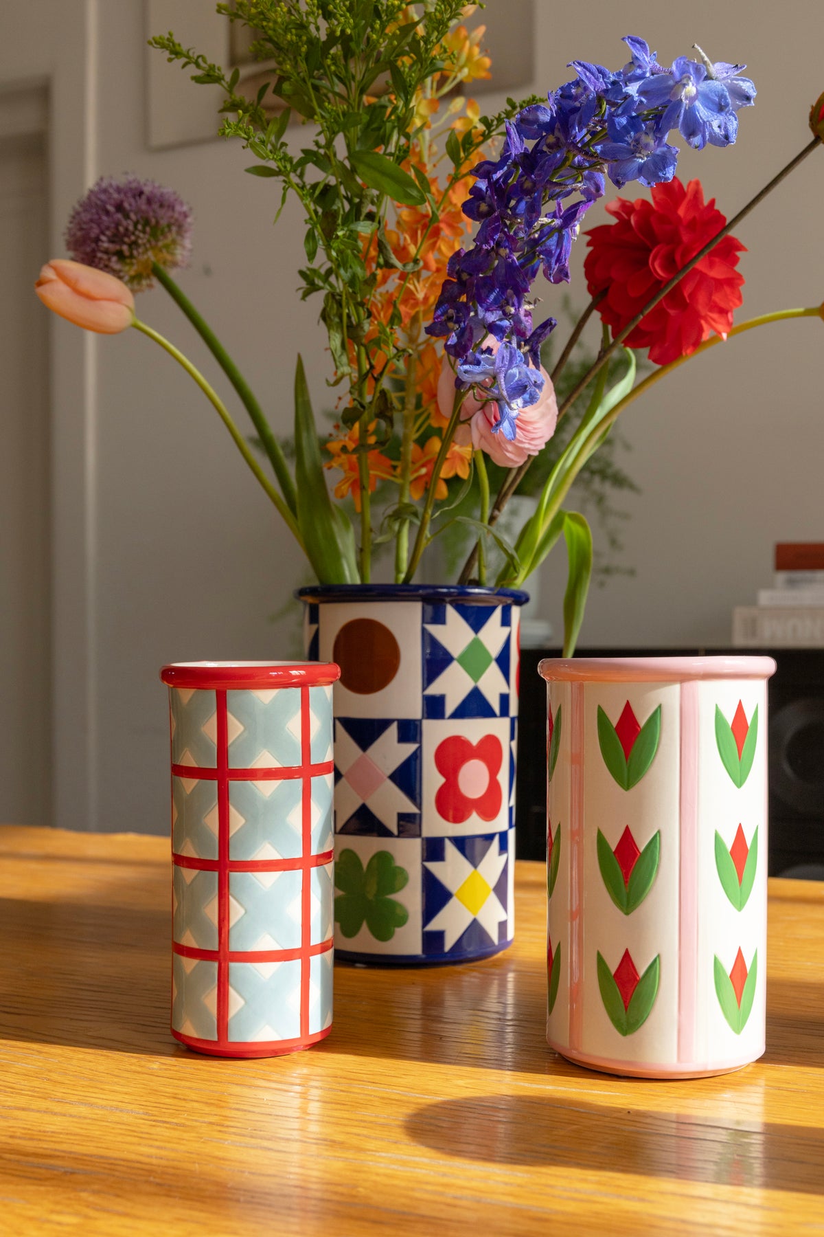 Patch Quilt vase with other patterned vases full of flowers