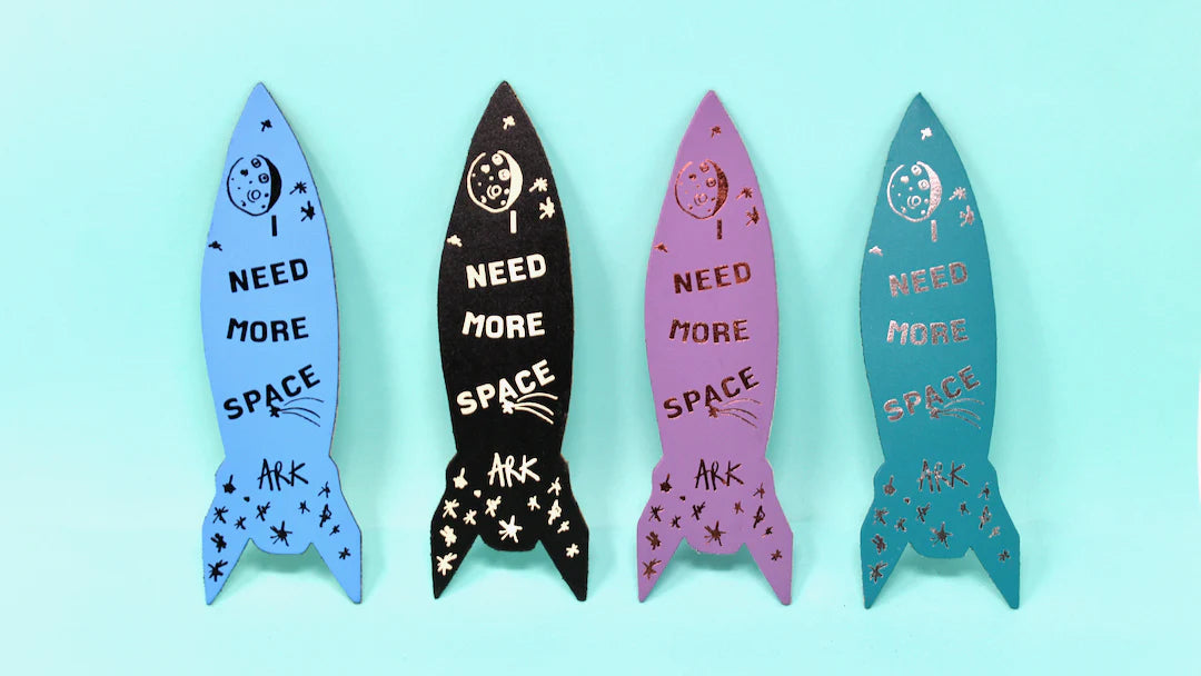 Row of rocket bookmarks in blue, black, pink and teal: Need more space
