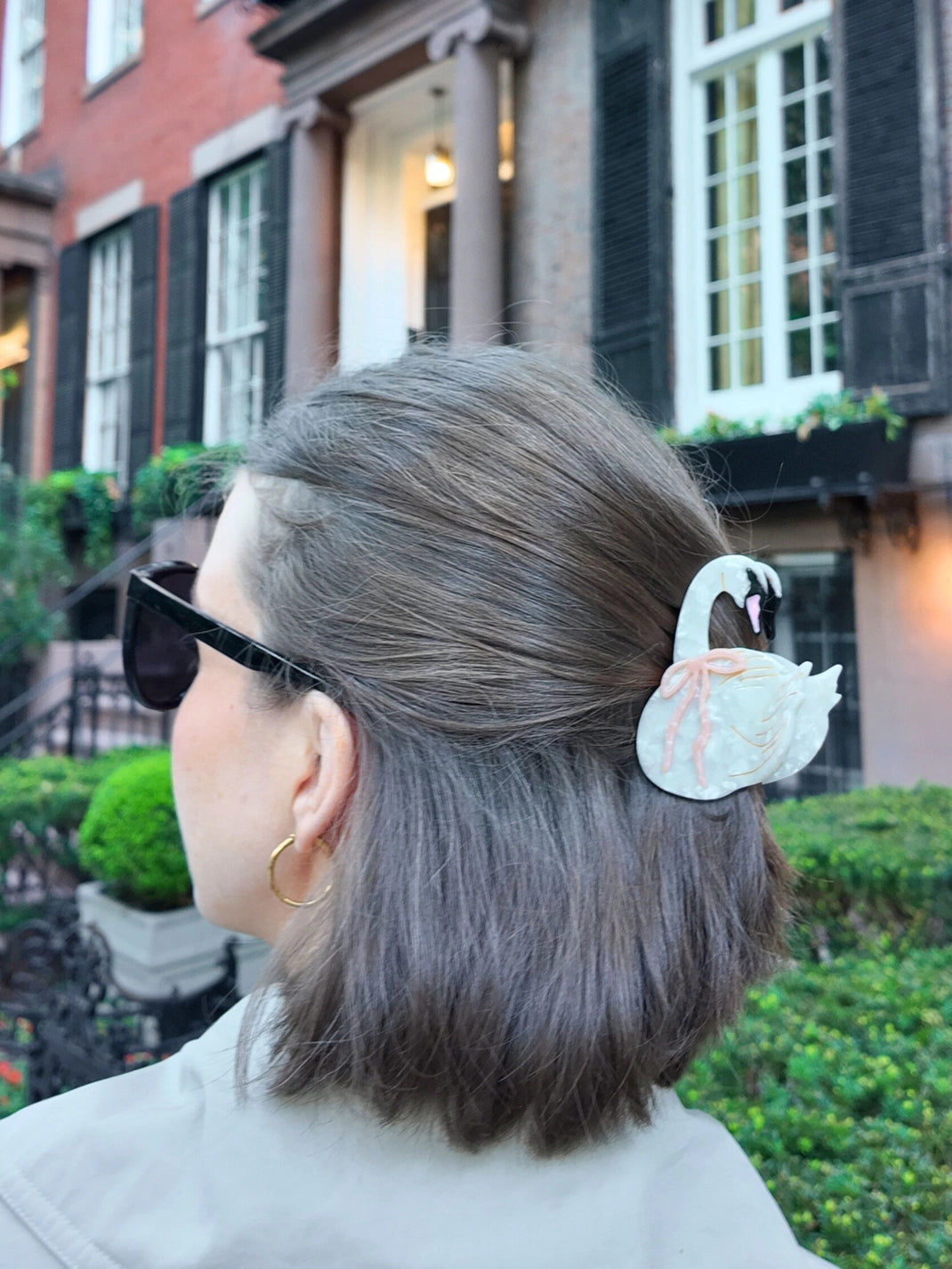 Swan claw clip in a grey-brown bob