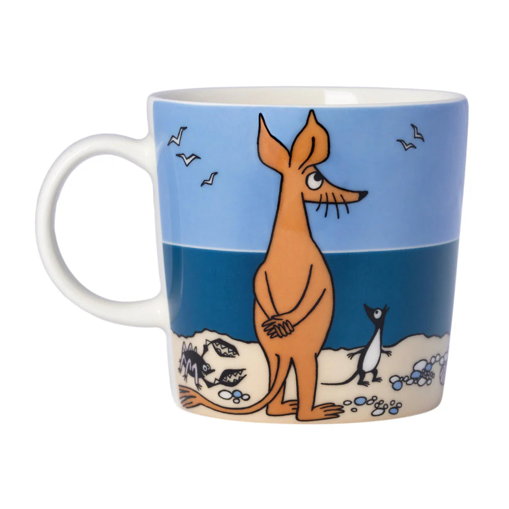 Other side of the Sniff mug: Sniff standing on the shore with a crab and seabirds