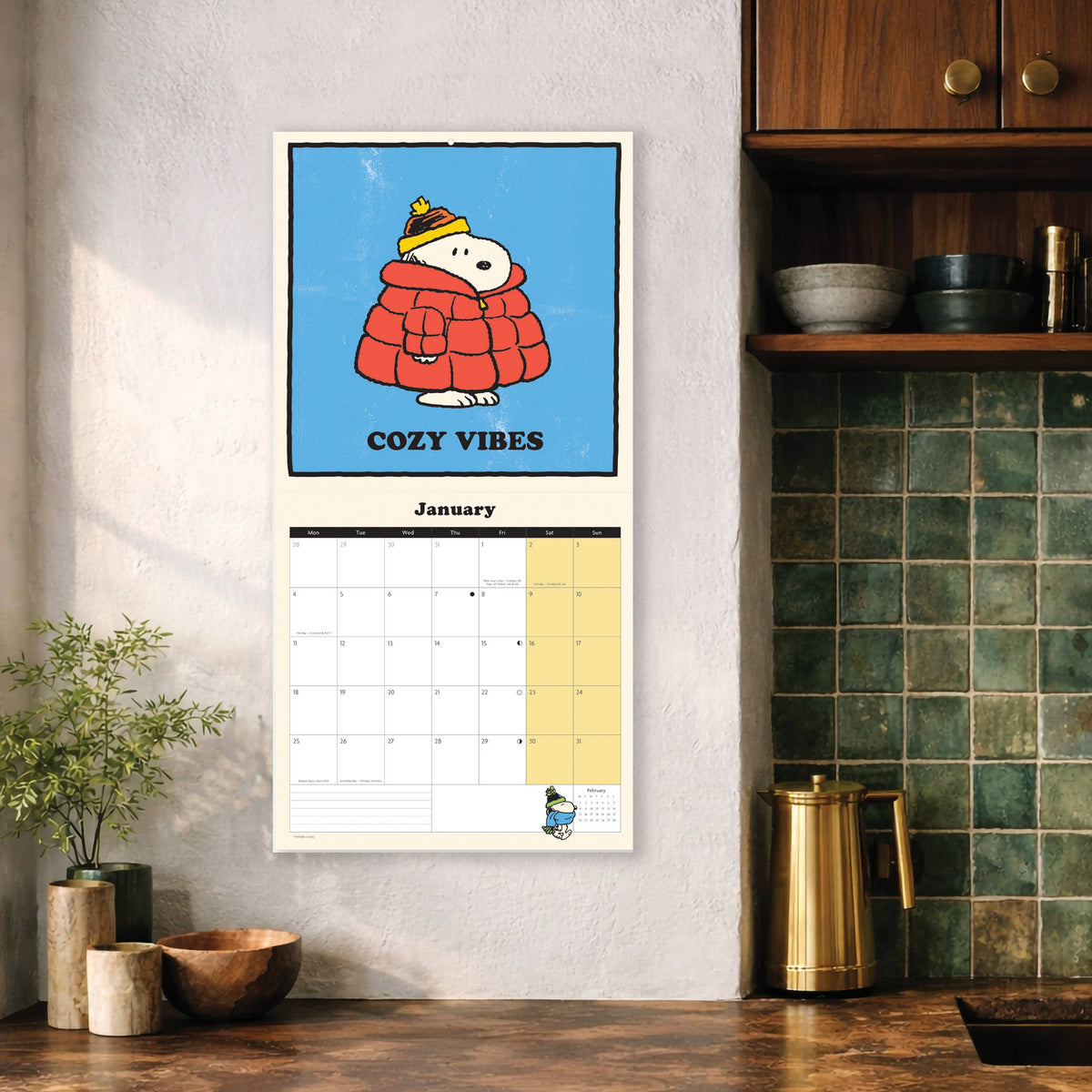 Snoopy calendar hanging on a kitchen wall