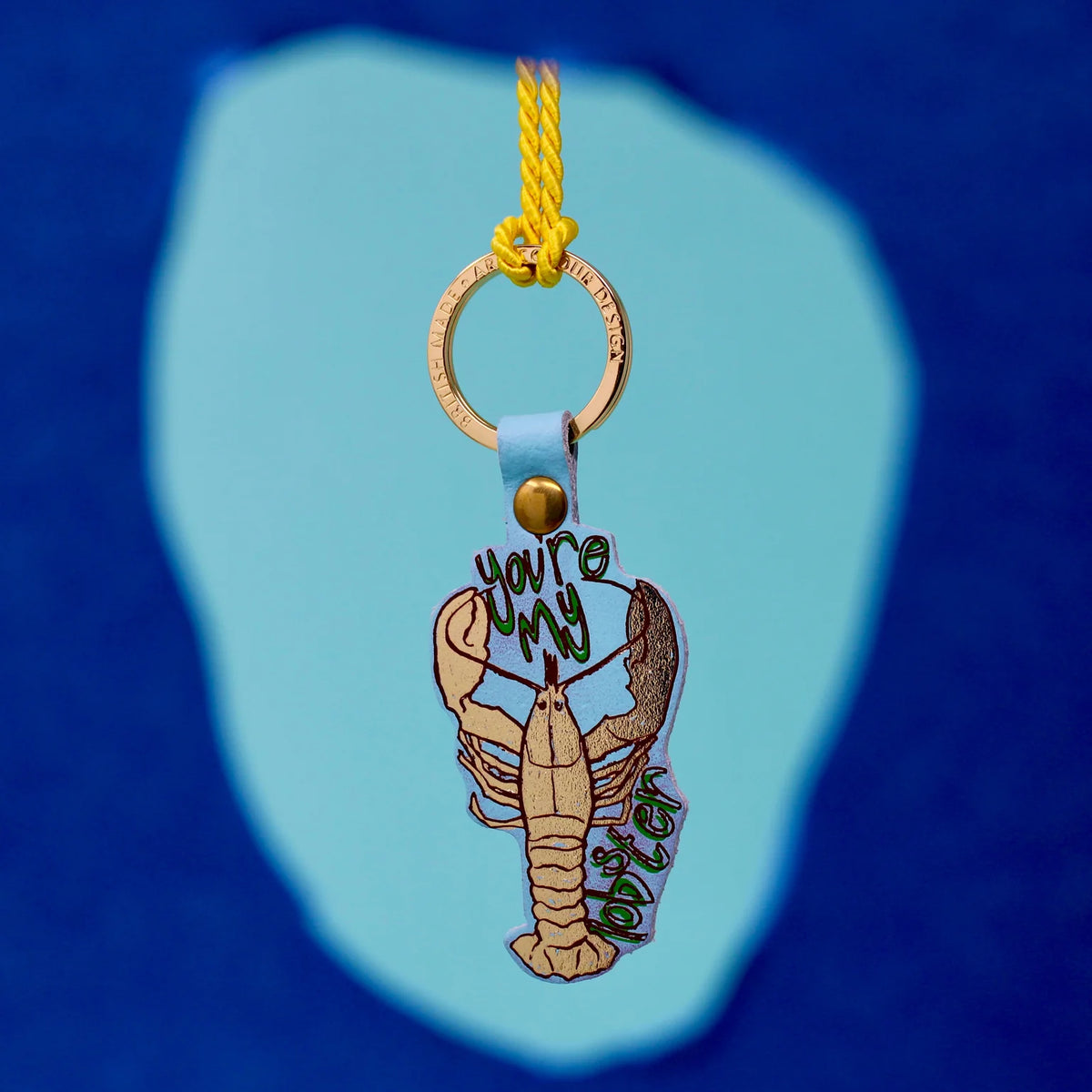 Blue lobster key fob hanging from a yellow cord