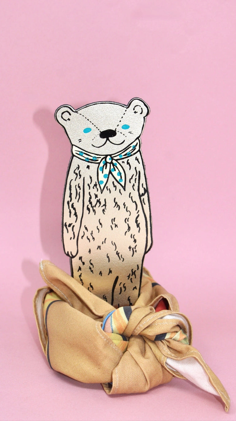 Gold bear bookmark standing in a knotted scarf