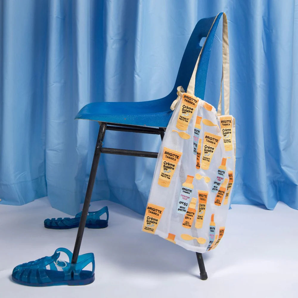 Sun Creme bag on a blue chair