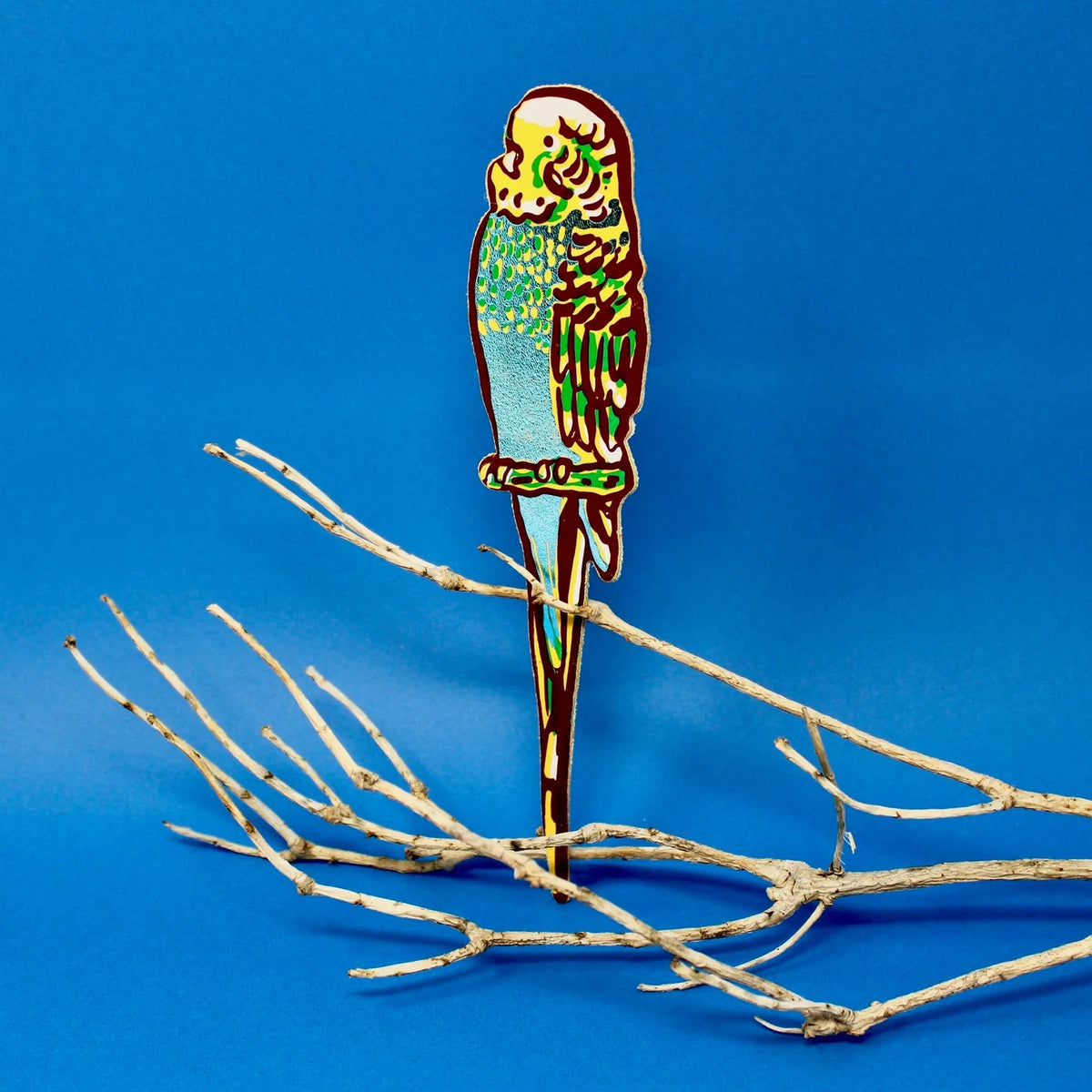 Leather budgie bookmark in green and yellow, perched on a branch