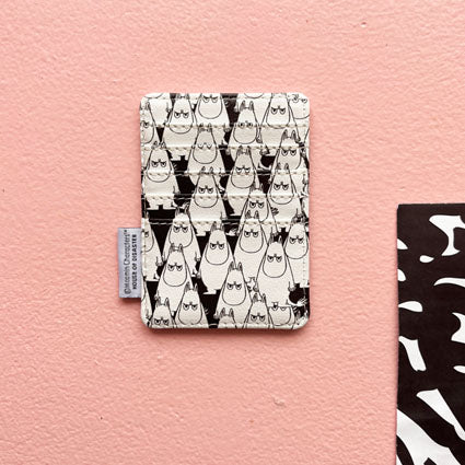 Back of the Moomin card holder with a pattern of angry Moomins