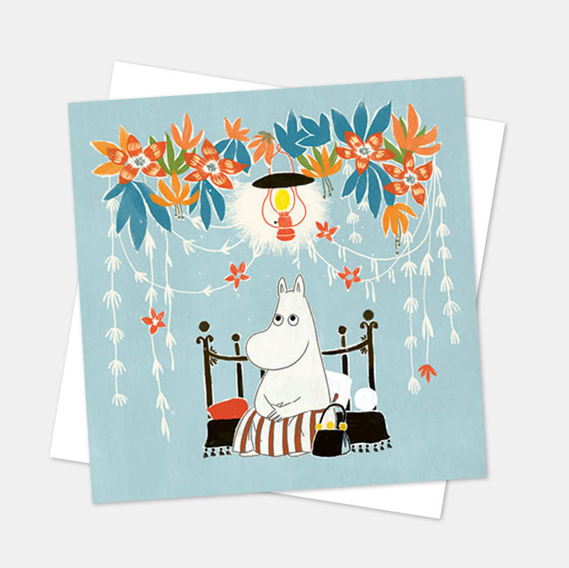 Moomin card of Moominmamma sitting under hanging flowers and a lamp