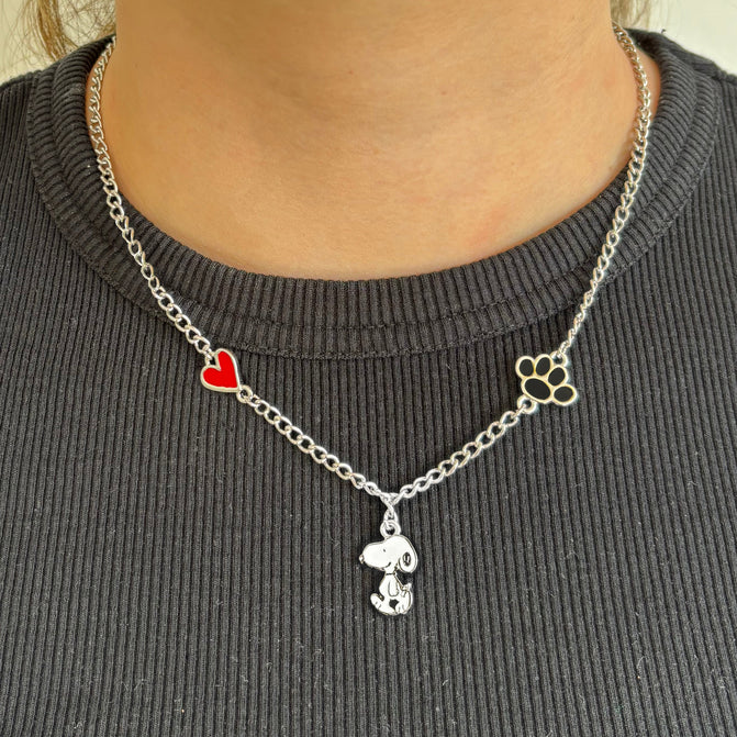Snoopy charm necklace worn with a grey top