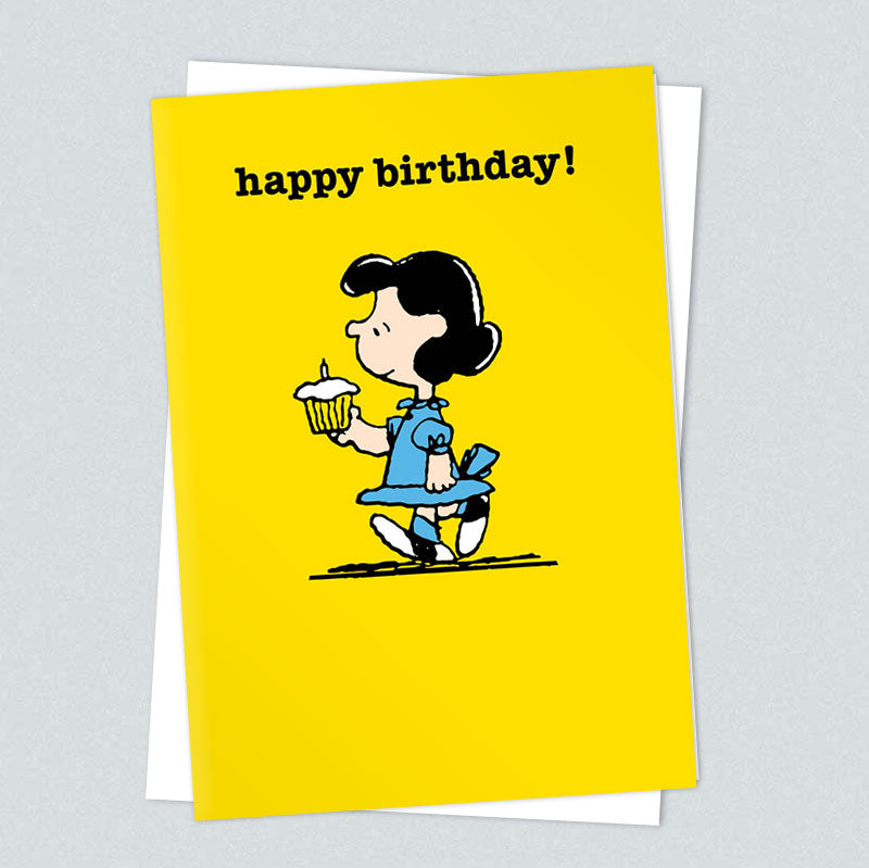 Yellow card of Lucy carrying a cupcake: happy birthday!