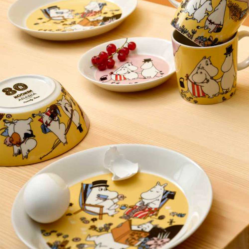 Family Time plate with a matching mug and bowls on a table