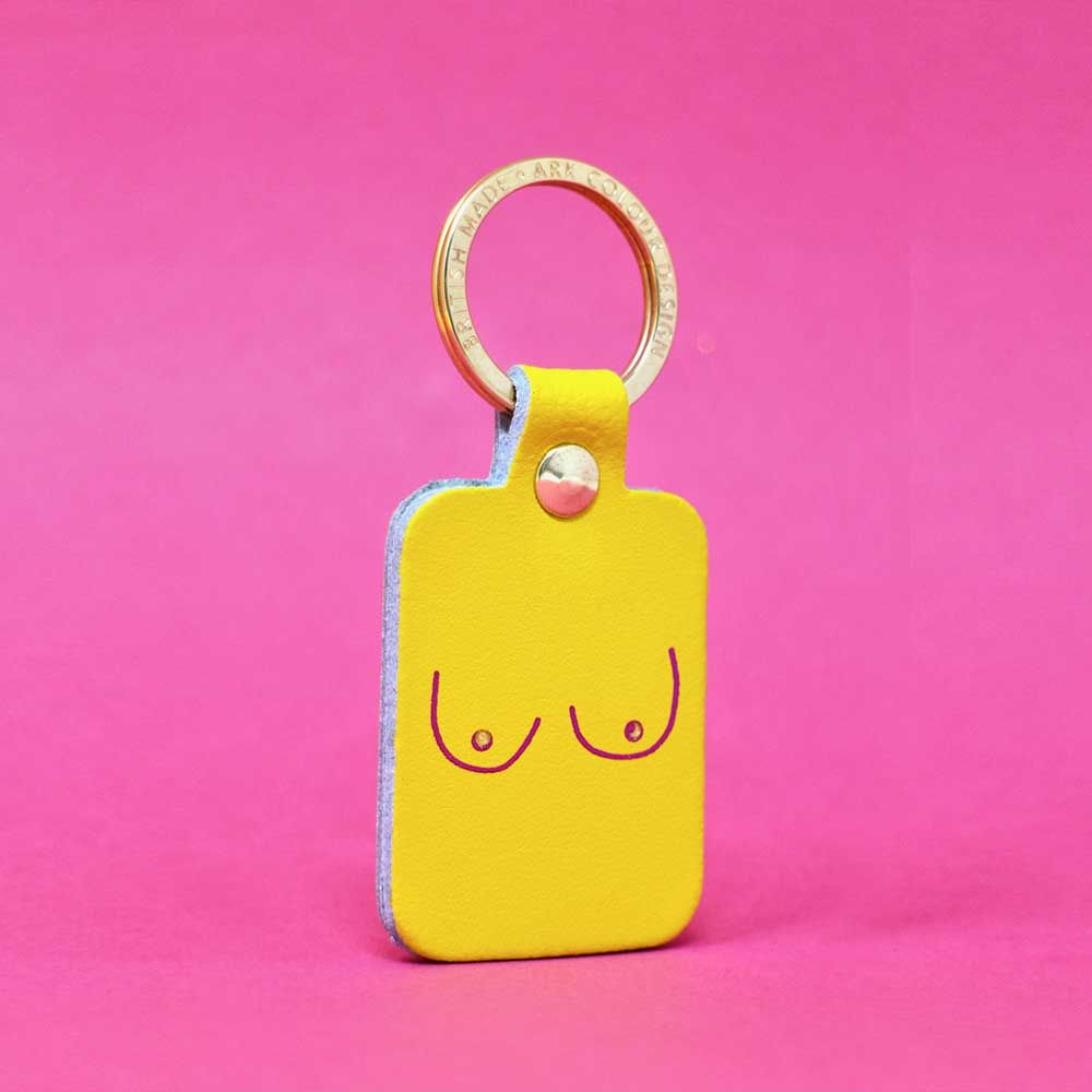 Yellow leather key fob printed with a pair of boobs