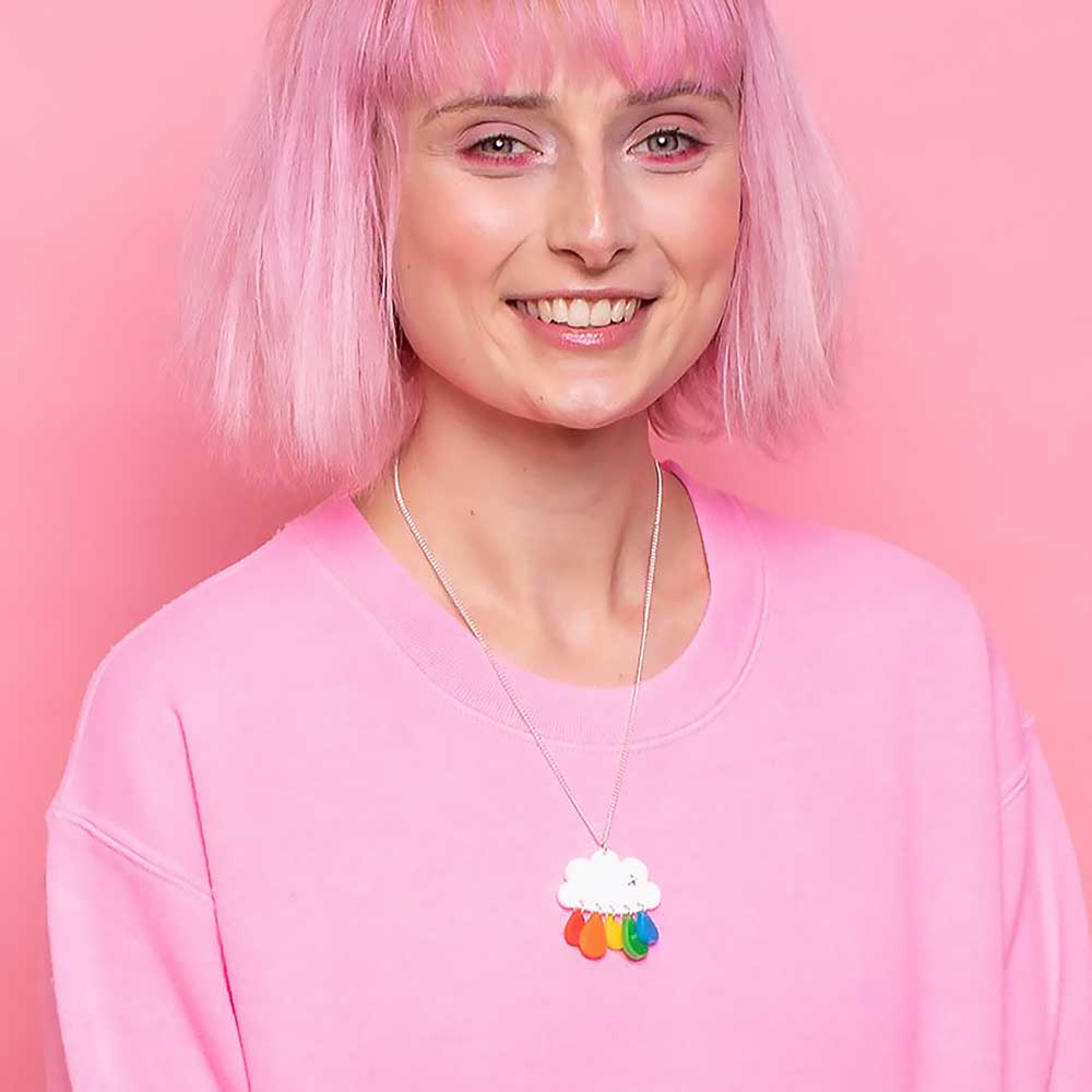 Smiling woman with pink hair wearing the cloud necklace
