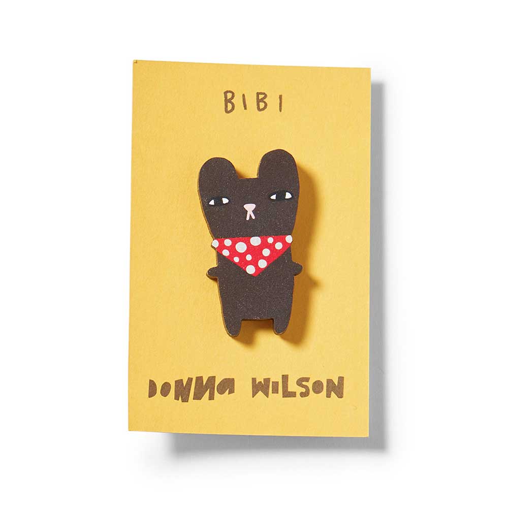 Brown bear pin badge in a red spotted neckerchief on a yellow card: Bibi