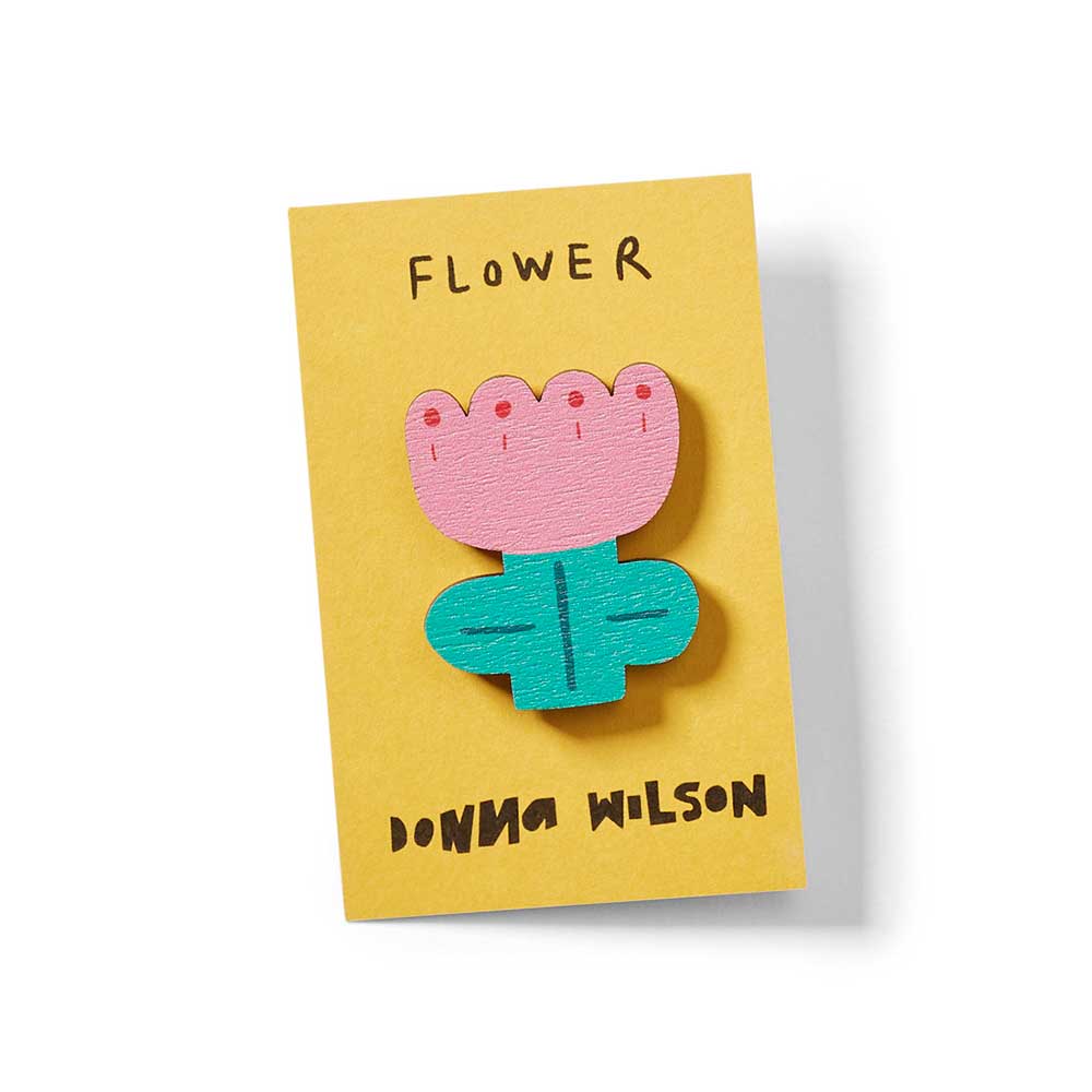 Donna Wilson flower pin badge, close-up on its card