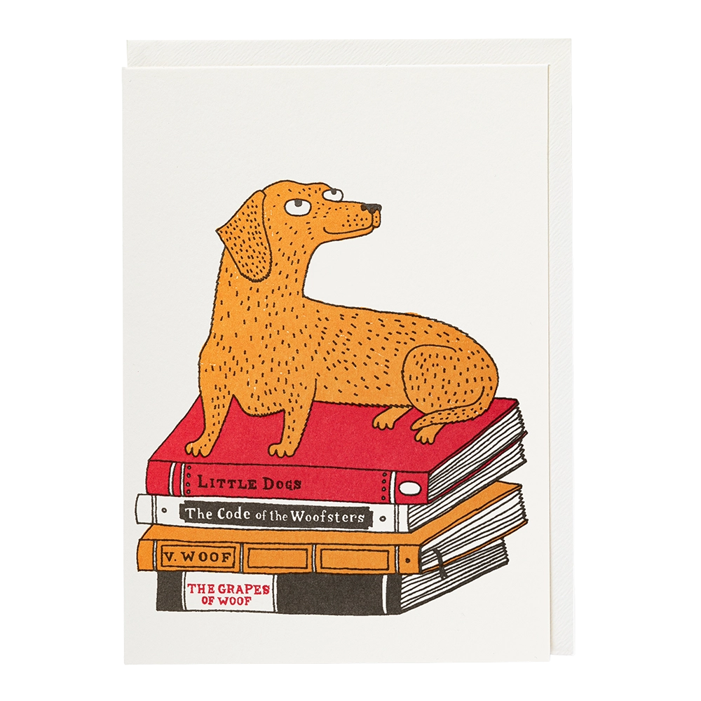 Archivist letterpress card: a dachshund lying on a stack of dog-themed books