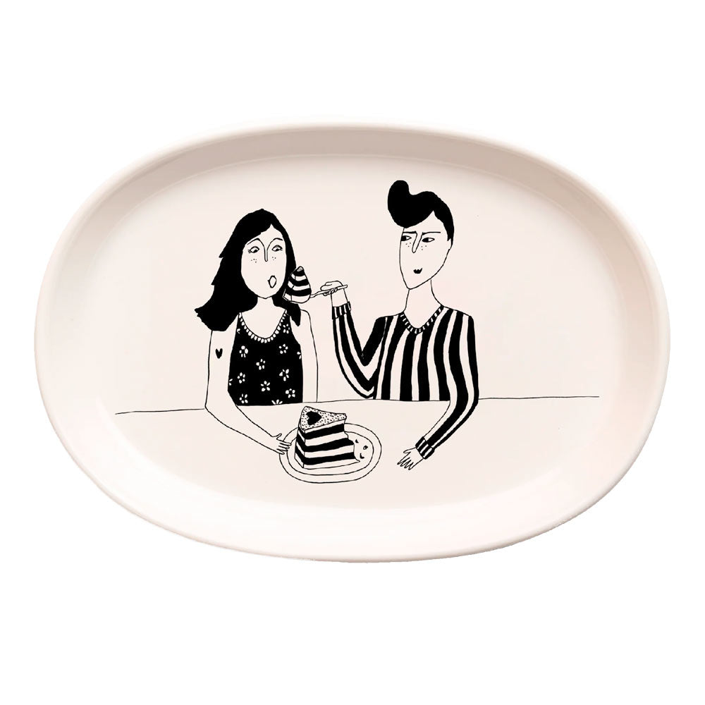 Oval porcelain dish with a drawing of two people sharing a slice of cake