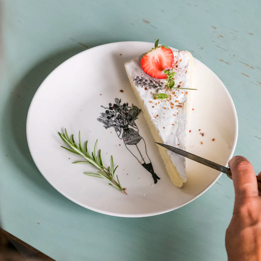 Flower Girl plate with a slice of cheesecake and a strawberry