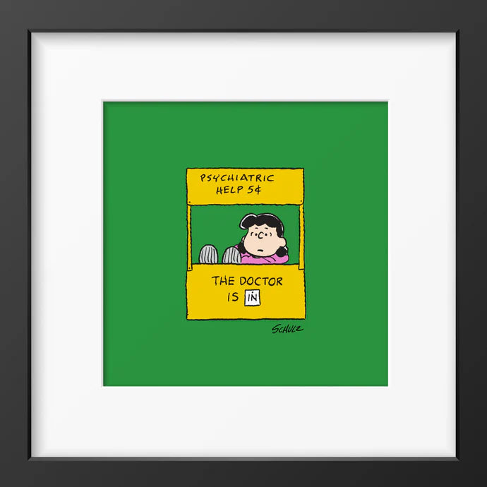 Peanuts framed print: Lucy in her 'Psychiatric help 5¢' booth on green, in a black frame