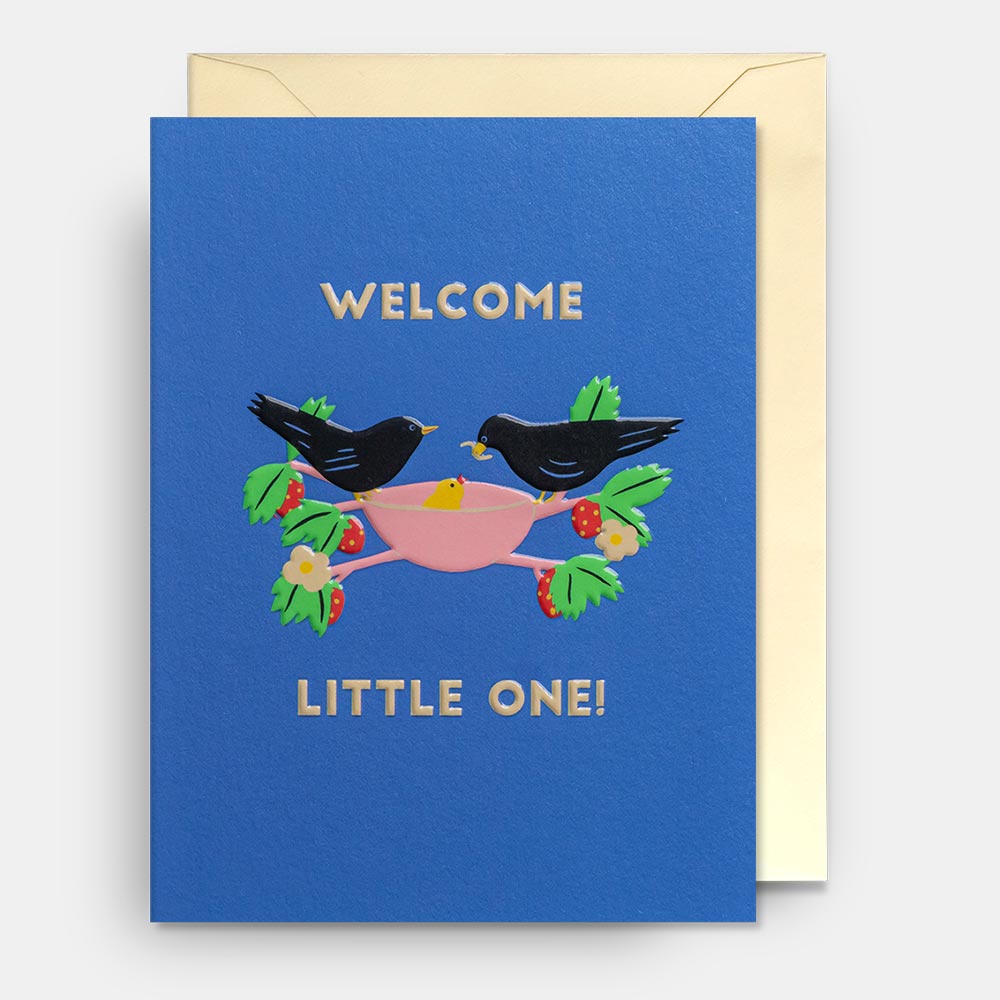 Lagom mini card: two blackbirds holding a pink ribbon on blue, with 'Welcome little one!'