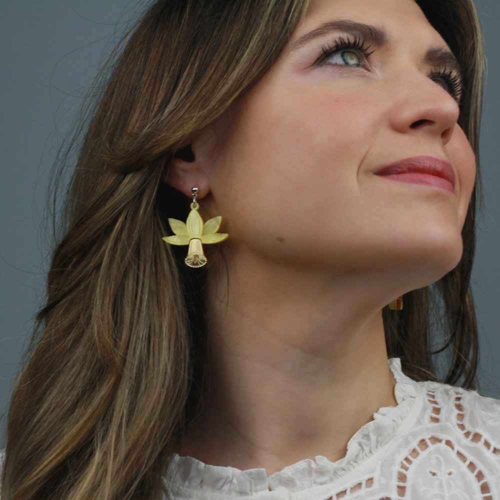 Woman wearing a yellow daffodil earring