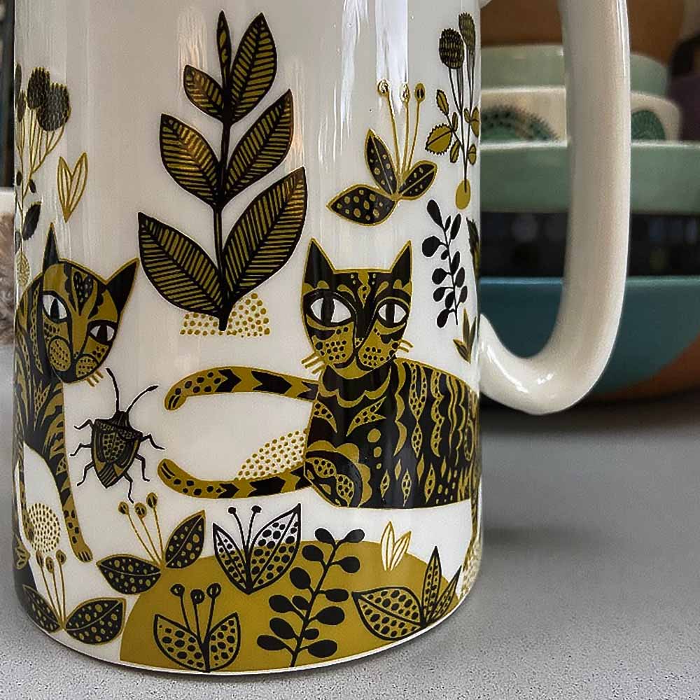 Close-up of the cats and plants on the jug