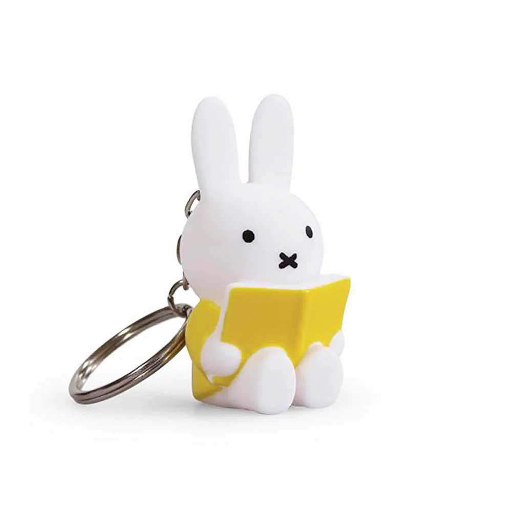 White Miffy figure keyring holding a yellow book