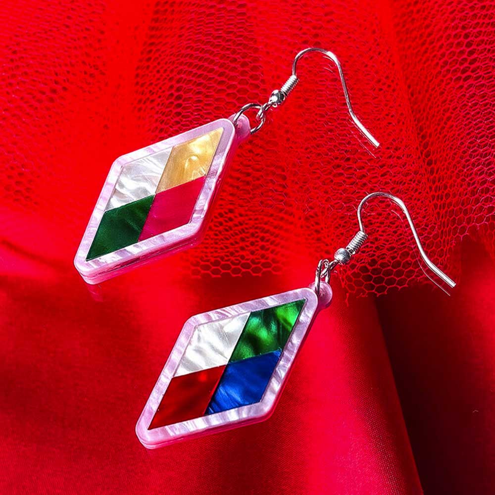 Harlequin earrings on red tulle