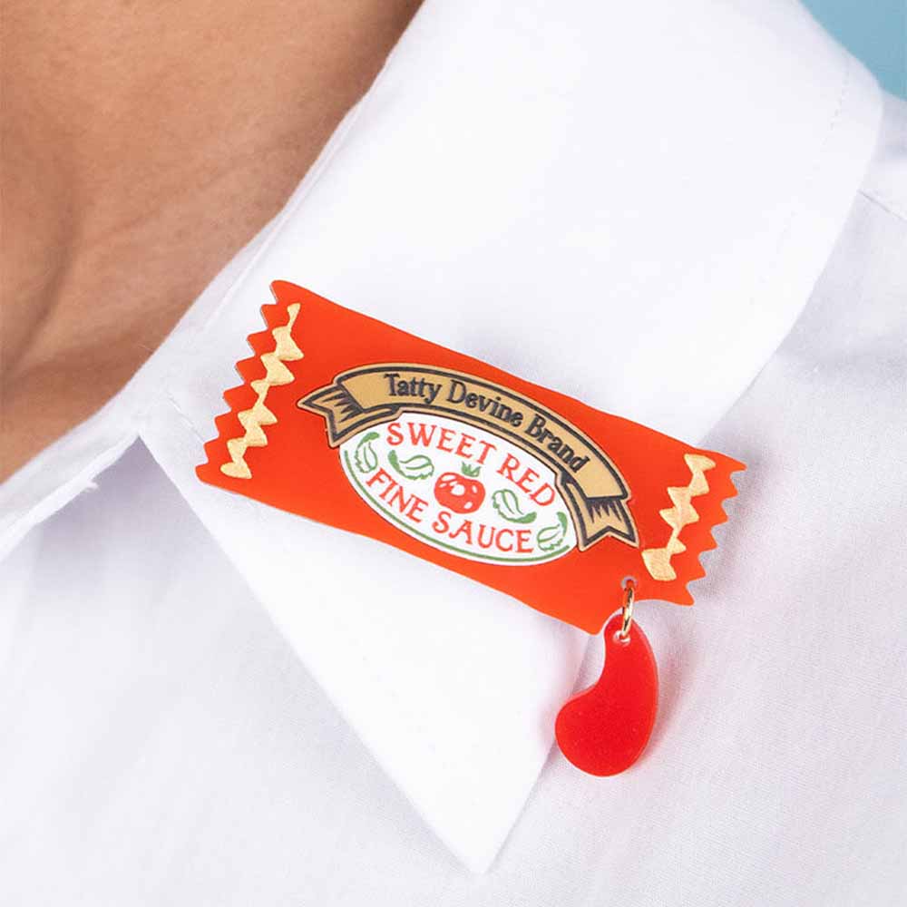 Ketchup brooch on a white shirt collar