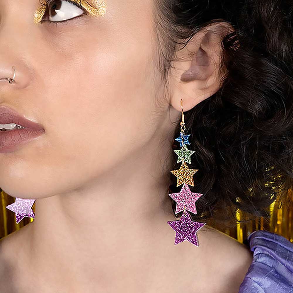 Woman wearing the long glitter star earrings