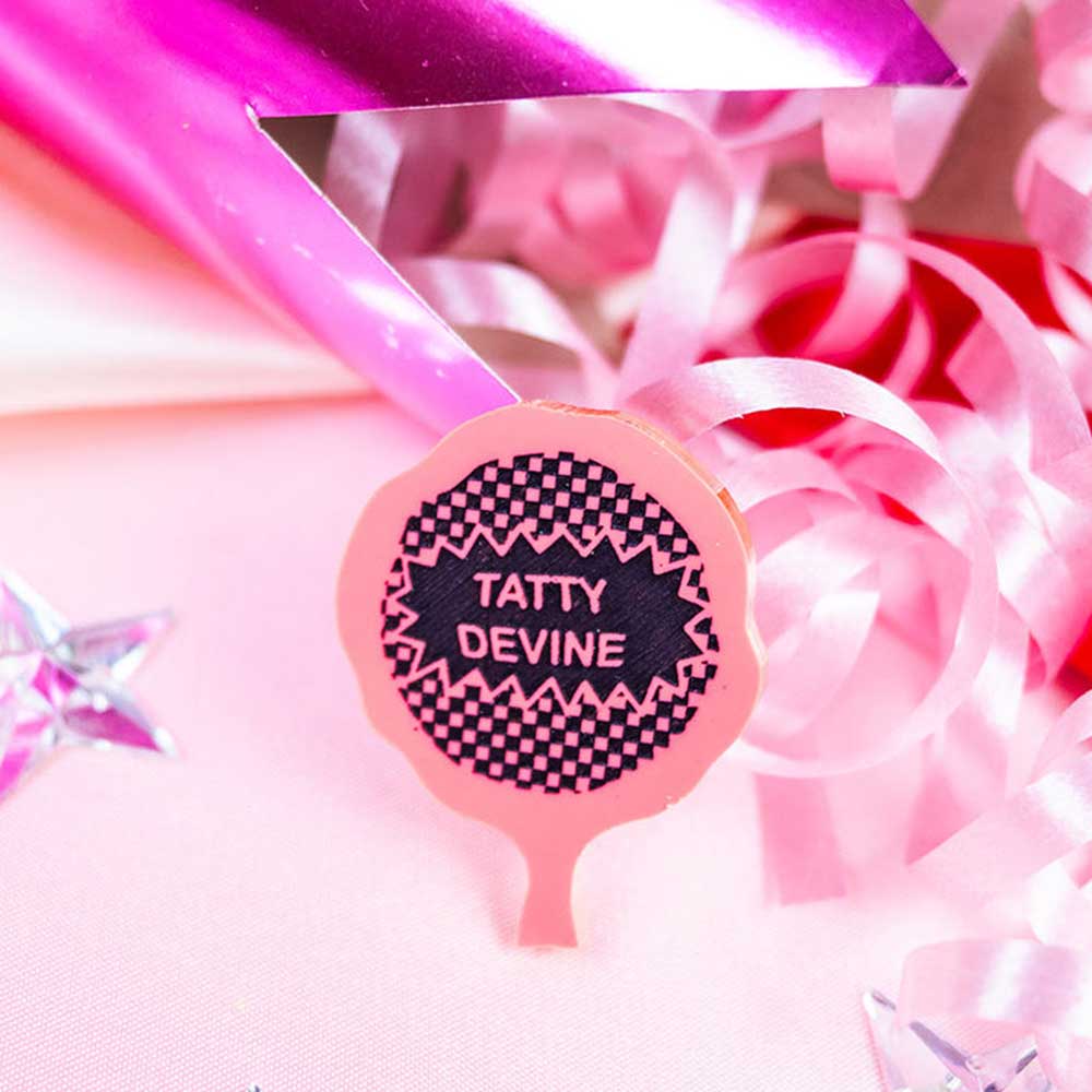 Whoopie cushion brooch among pink ribbons