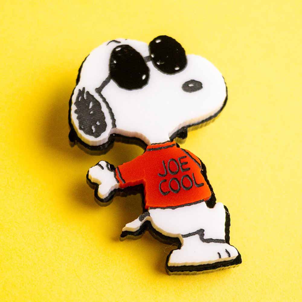 Joe Cool brooch on a yellow background