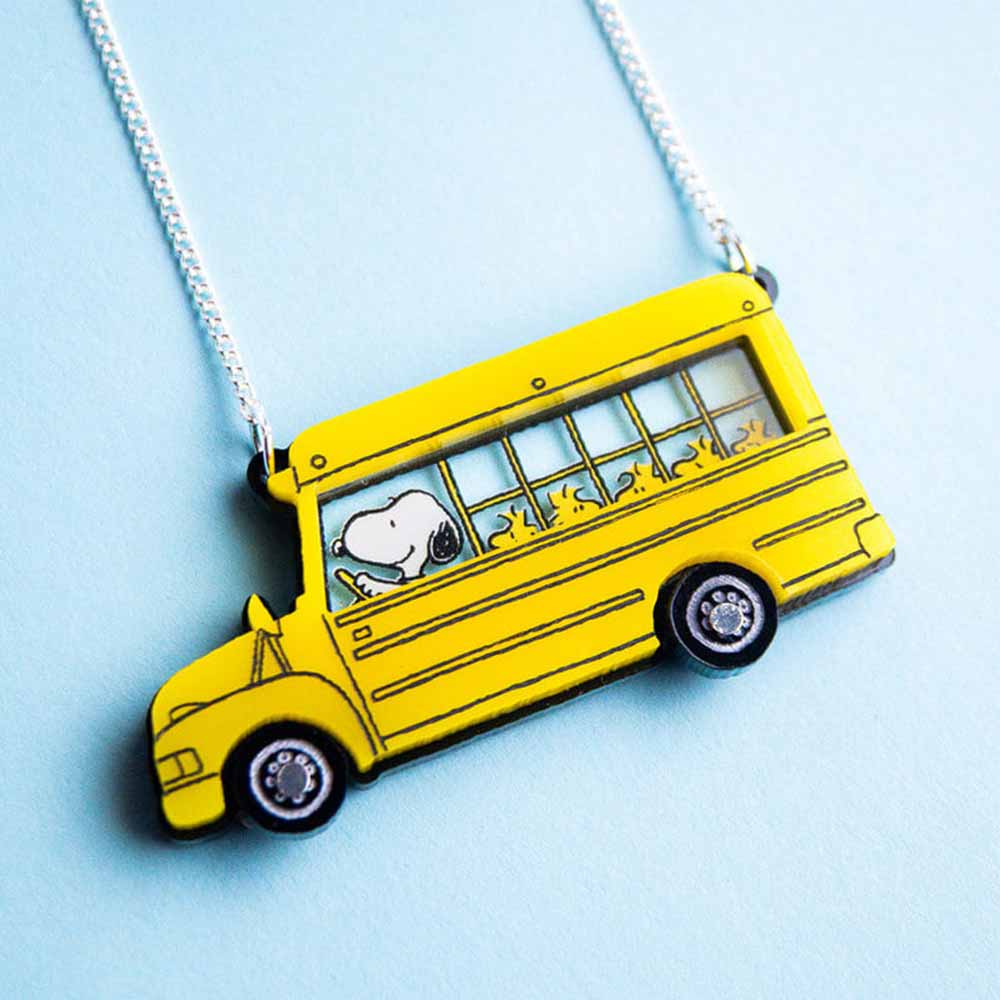 School bus necklace on a pale blue background