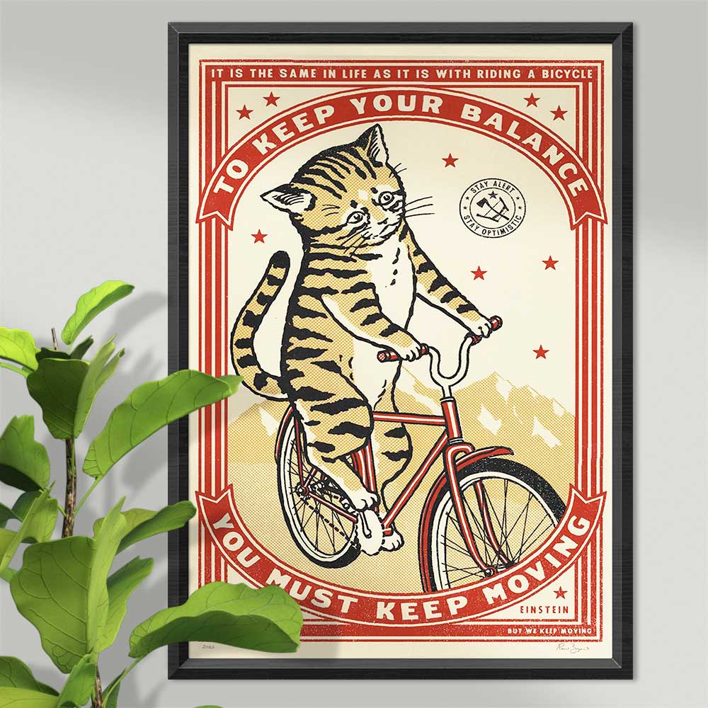 Framed screenprint of a tabby cat riding a bicycle: To keep your balance you must keep moving