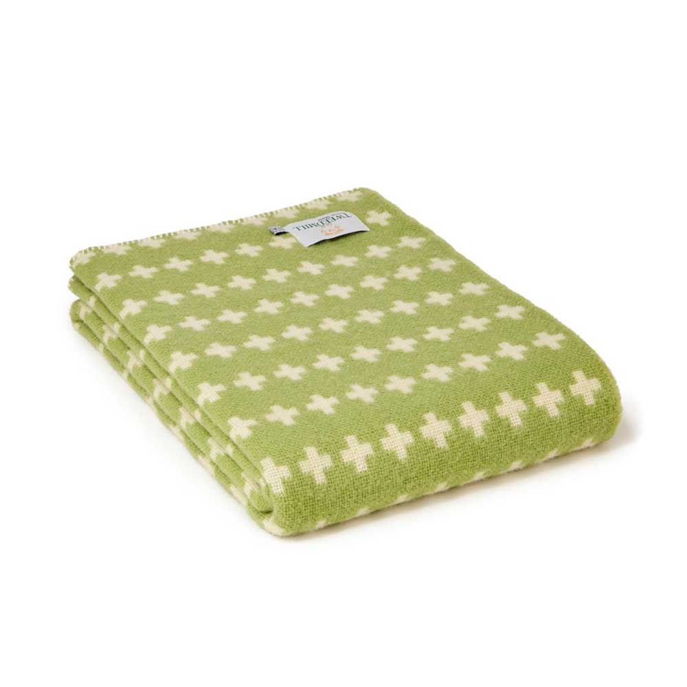 Tweedmill green blanket with a cream cross pattern, folded