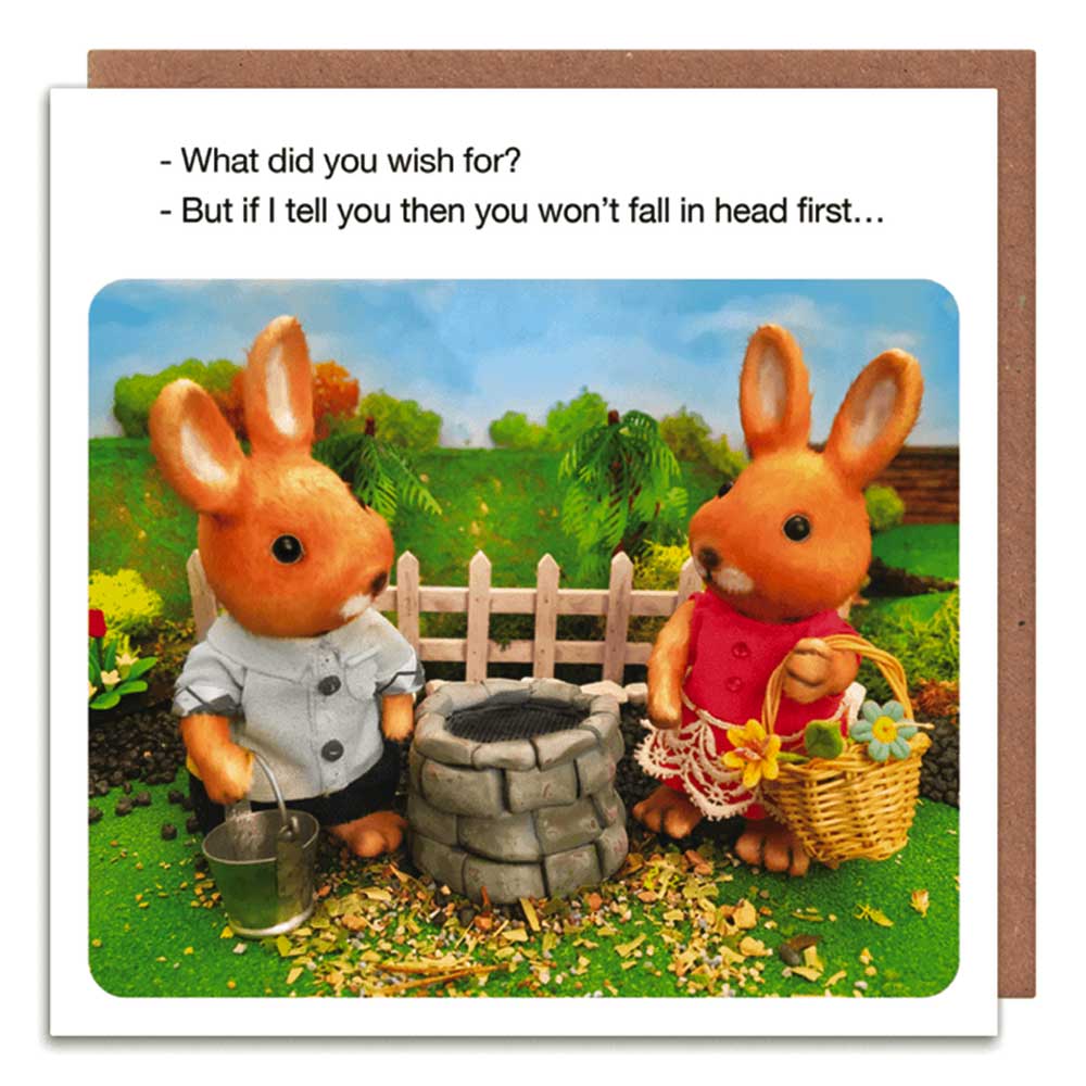 Card of two toy rabbits at a wishing well: 'What did you wish for?' 'But if I tell you then you won't fall in head first...'