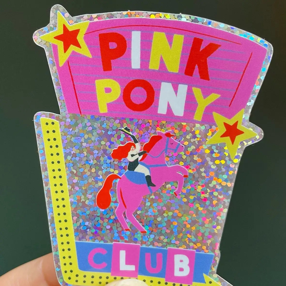 Naomi Wilkinson holographic sticker: a pink cowgirl on a horse with 'Pink Pony Club'