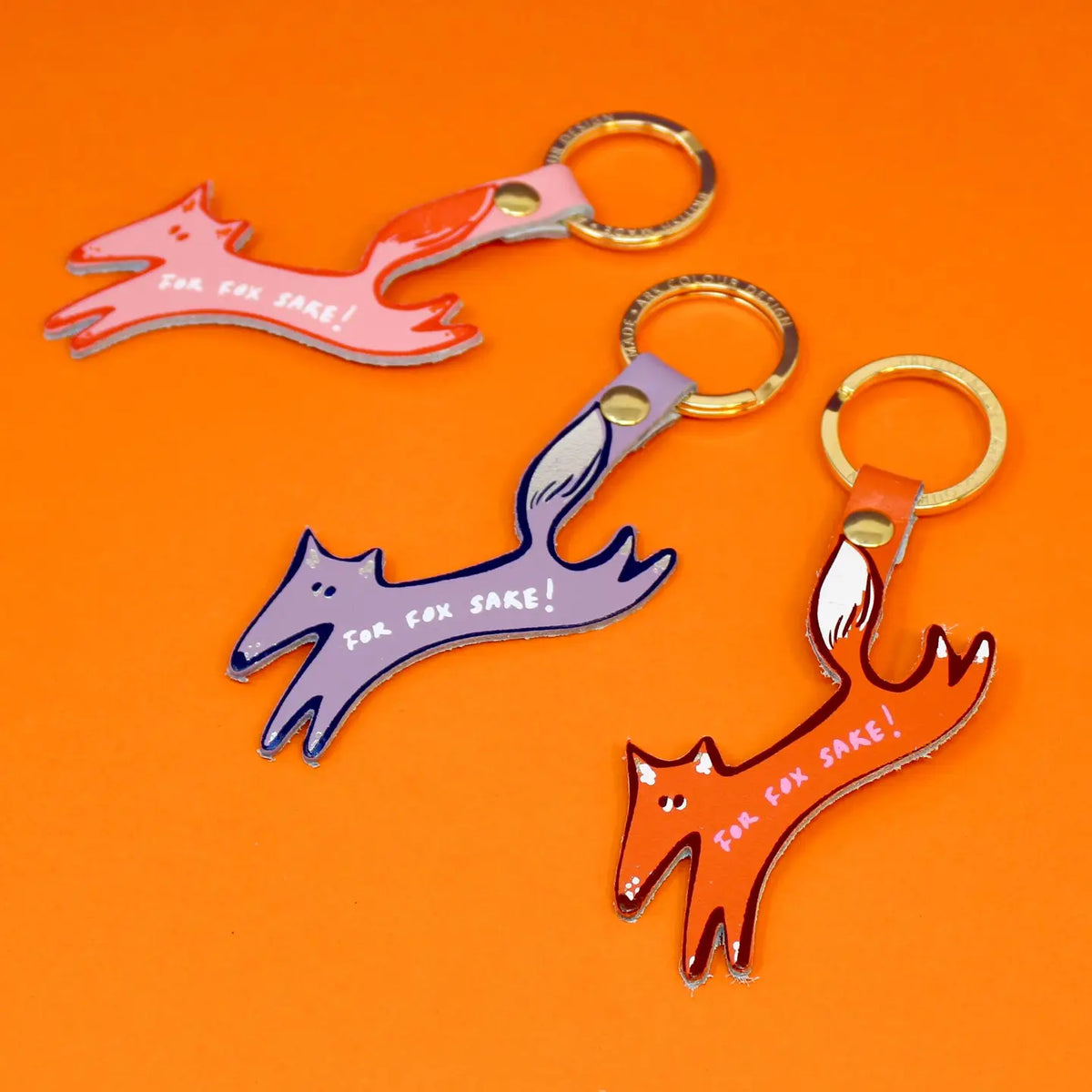Ark 'For fox sake' key rings: leather fox shapes in pink, lilac and orange on an orange background