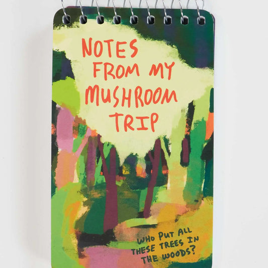 Blue Q mini spiral notebook: a colourful forest with 'Notes from my mushroom trip' and 'Who put all these trees in the woods?'