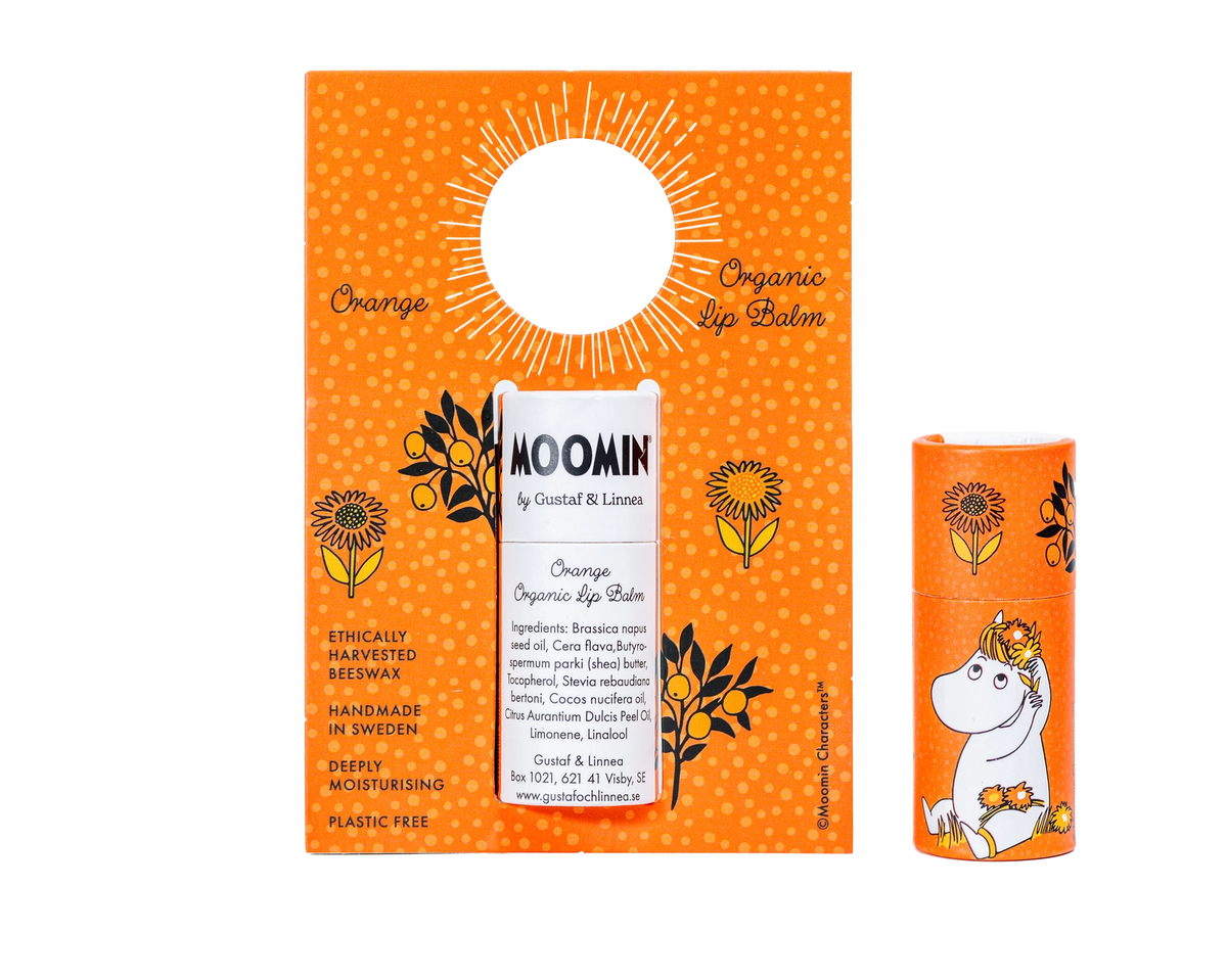 Moomin orange organic lip balm with Snorkmaiden, beside its orange gift card