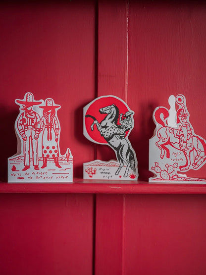 Archivist cut-out cards standing on a red shelf