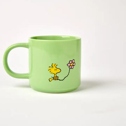 Back of the Posy mug with Woodstock holding a flower