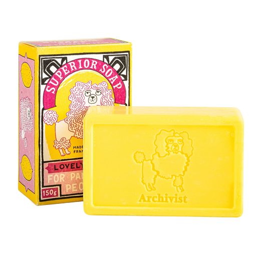 Yellow lemon soap bar stamped with a poodle beside its box
