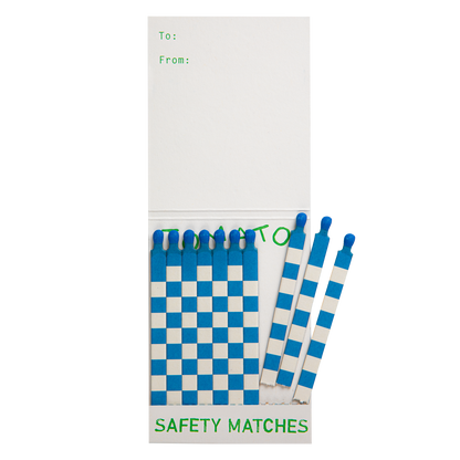 Inside the Tomato match book with blue and white matches and a To/From space