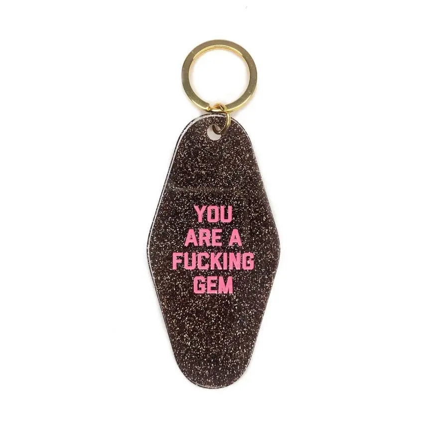 Golden Gems glittery brown motel-style key tag reading 'You are a fucking gem'