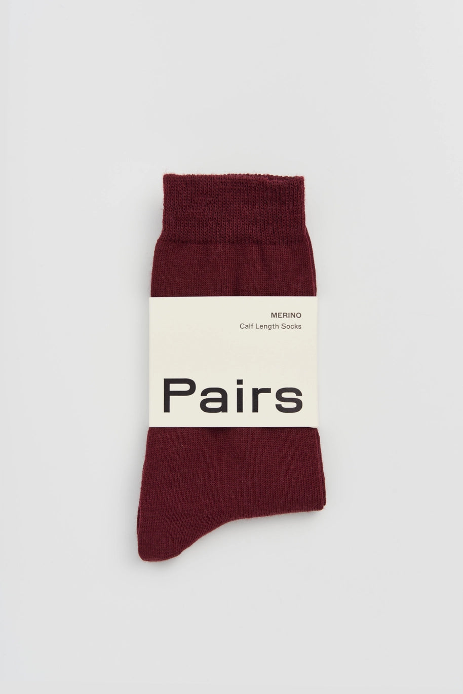 Pairs merino socks in dark plum, medium, with a Pairs paper band