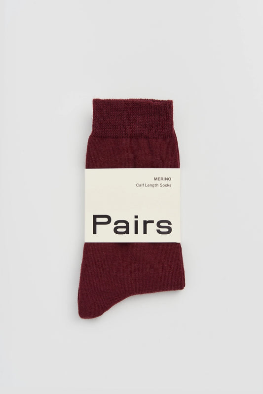 Pairs merino socks in dark plum, medium, with a Pairs paper band