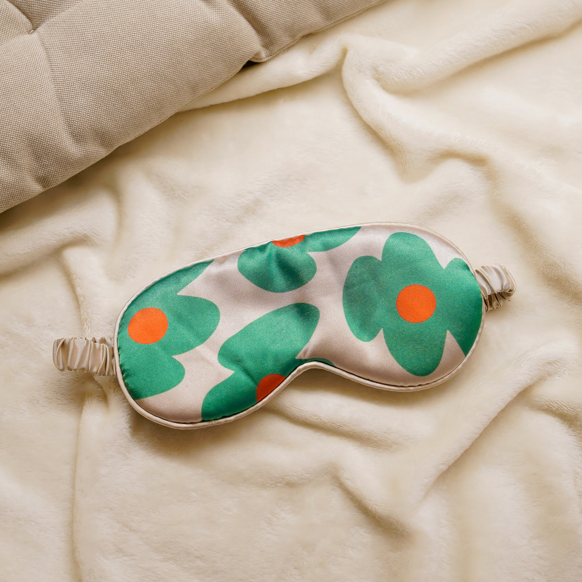 Green flower sleep mask on a soft blanket